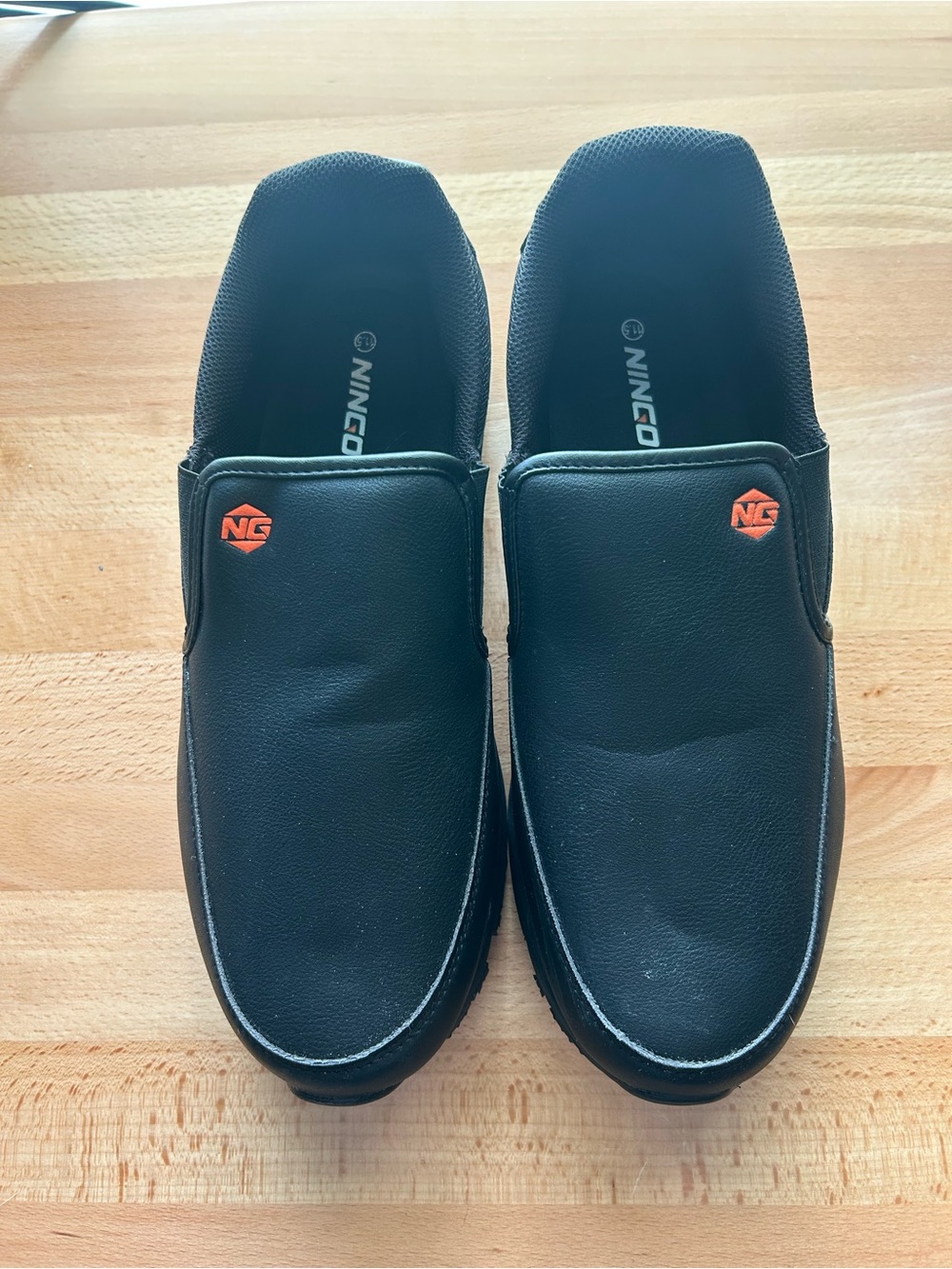 Ningco Men's Black Slip-On Loafers with Orange Logo Accent